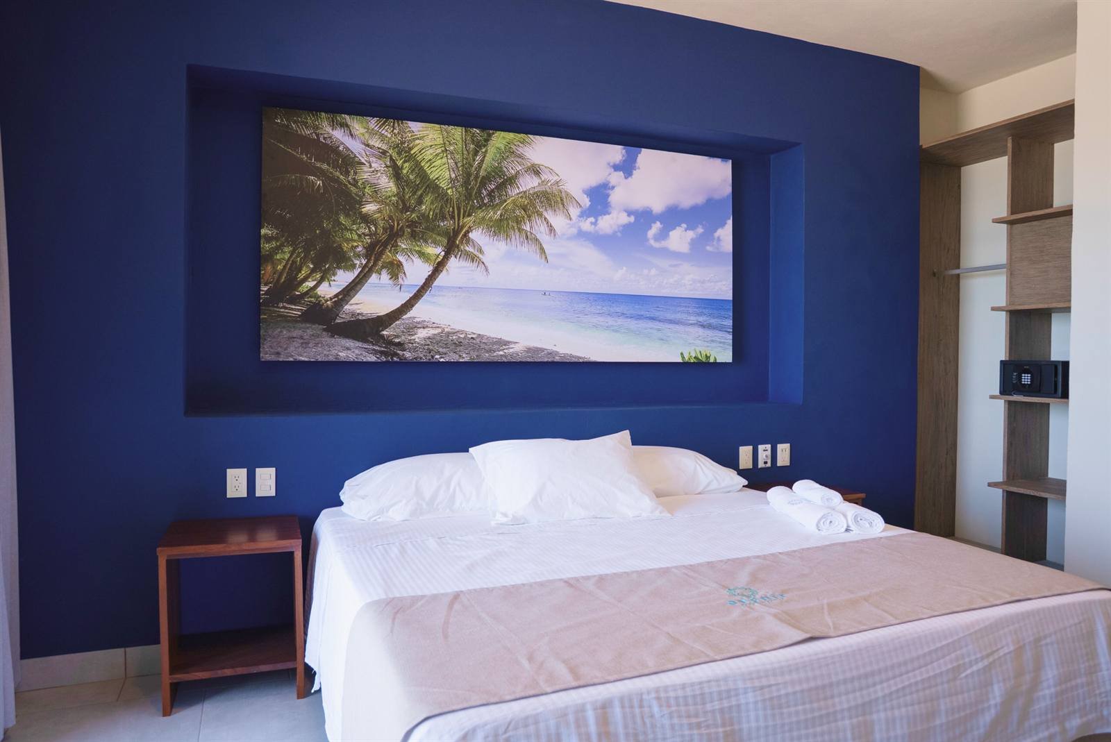 Avenir Armonia Suites: Deluxe ocean-view room with a King bed and a wall-mounted TV